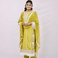 The outfit is a mustard yellow color with white embroidery and lace detailing.