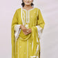 The outfit is a mustard yellow color with white embroidery and lace detailing.