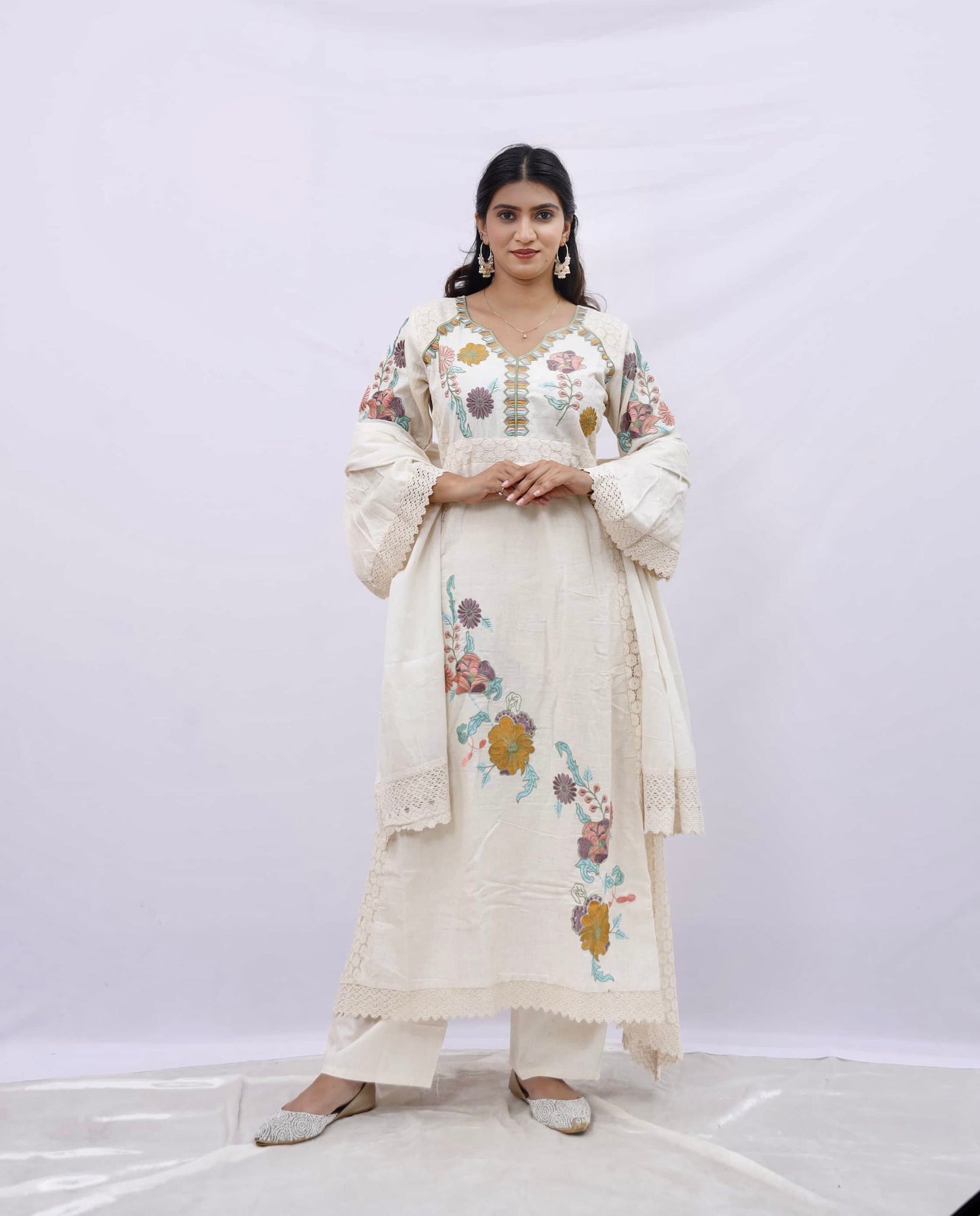 Three-piece suit consisting of a kurta (tunic), dupatta (scarf), and trousers.